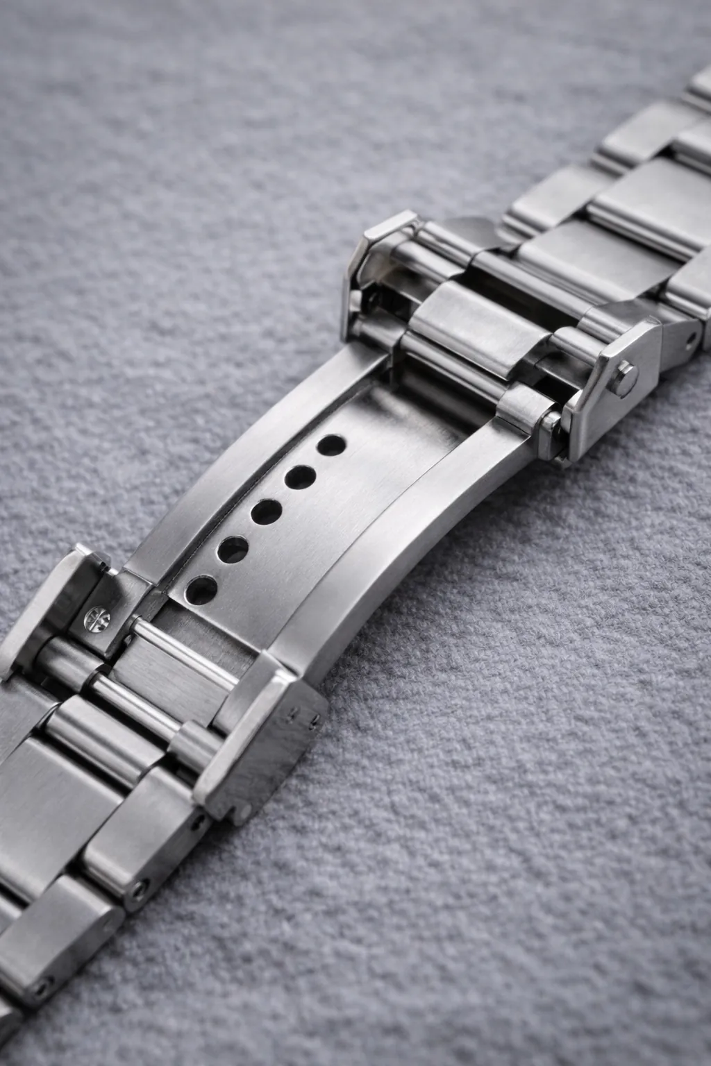 Open watch clasp showing micro-adjustment holes and internal clasp structure