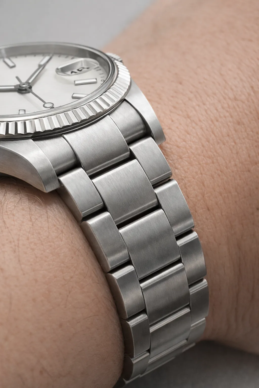 Watch bracelet integration with case shown on wrist to illustrate natural fit and link alignment