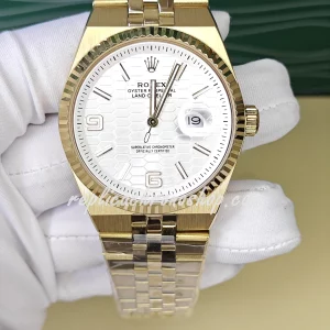 Replica Rolex Oyster Perpetual Date 127335 – 40mm White Honeycomb Dial, 14k Gold-Plated Stainless Steel Bracelet