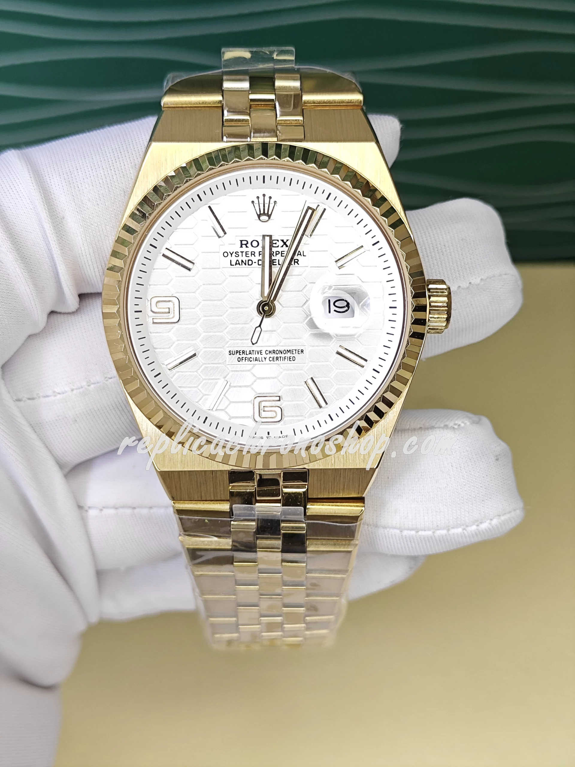 Replica Rolex Oyster Perpetual Date 127335 – 40mm White Honeycomb Dial, 14k Gold-Plated Stainless Steel Bracelet